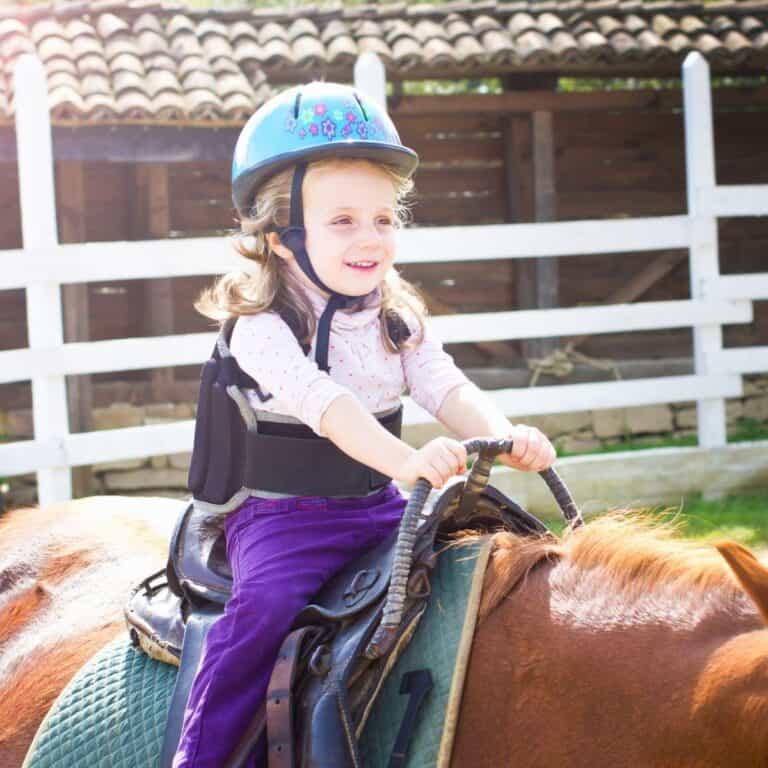 Girl in brace riding horse