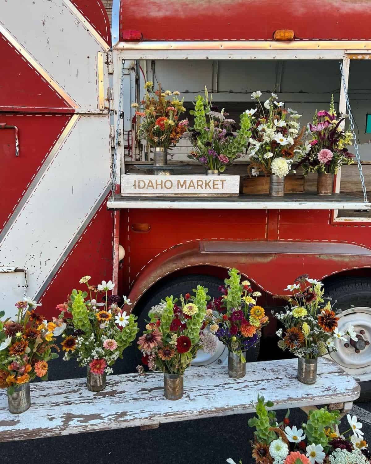 A red horse trailer rebuilded as a small flower shop.