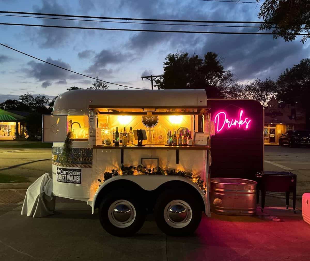 A horse trailer decorated with neon lights rebuilded as a small bar.