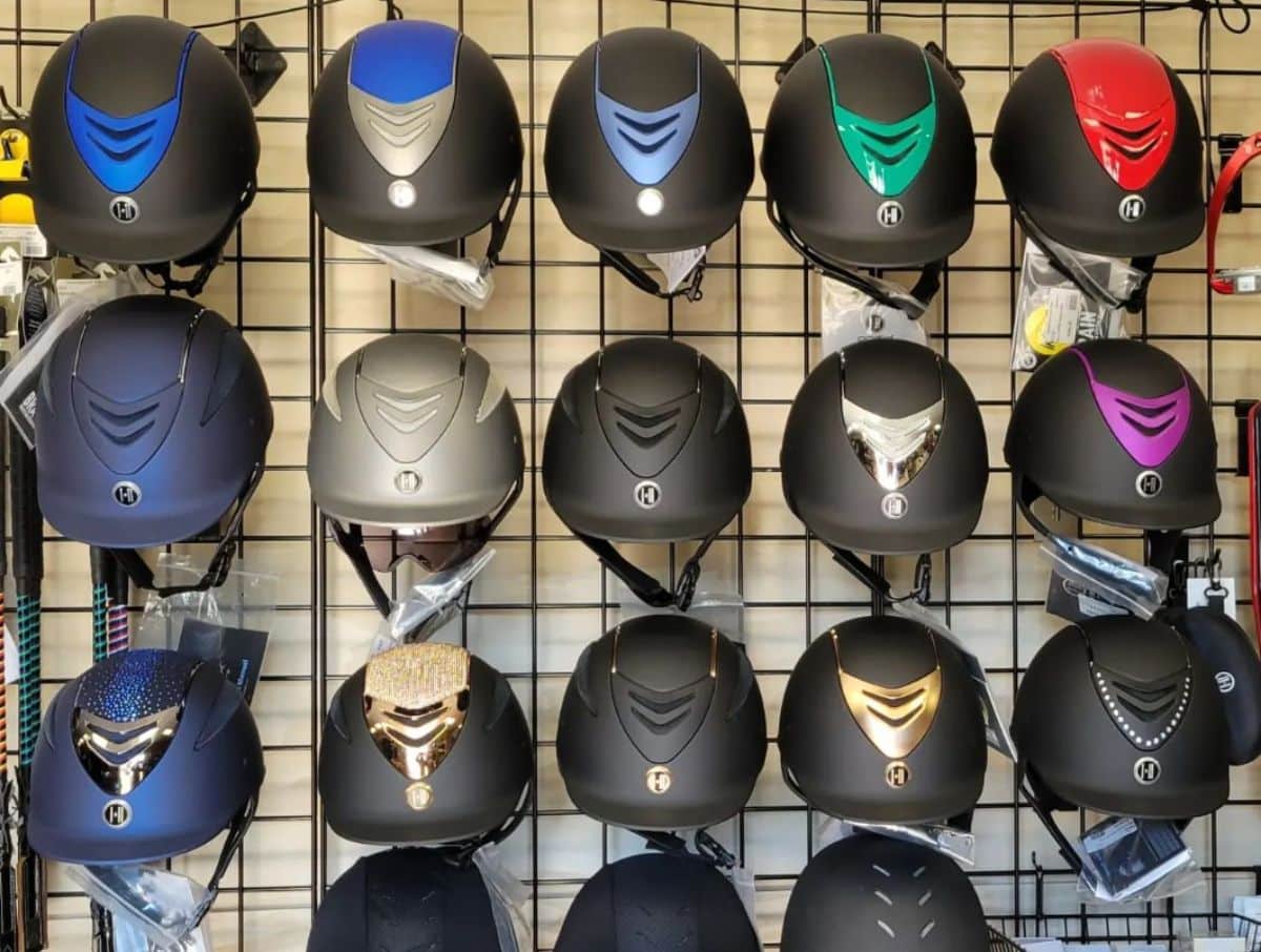 A rack of horse riding helmets.