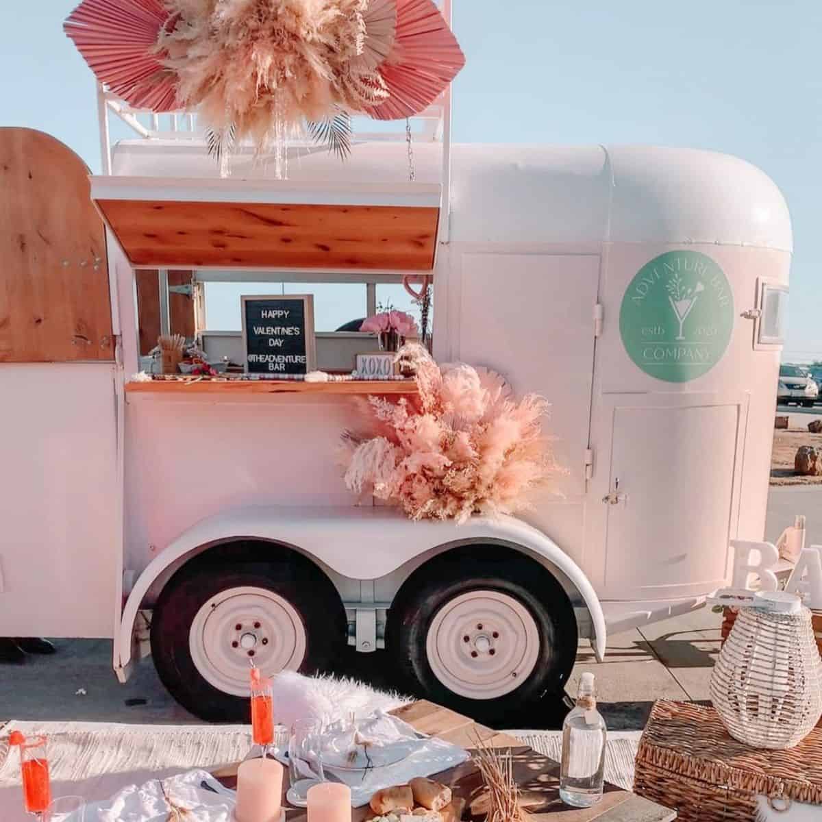 A pink horse trailer rebuilded as a small flower shop.