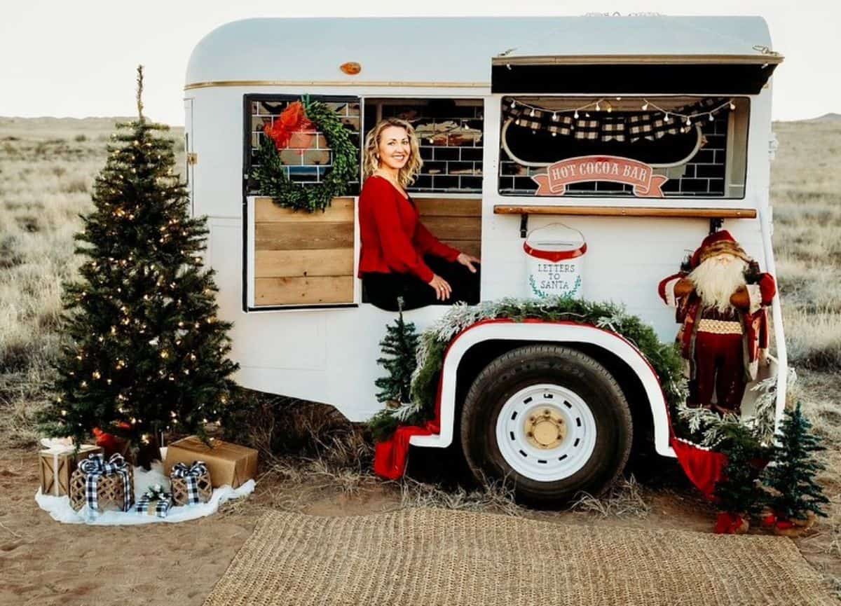 A horse trailer with christmas decor rebuilded as a small bar.