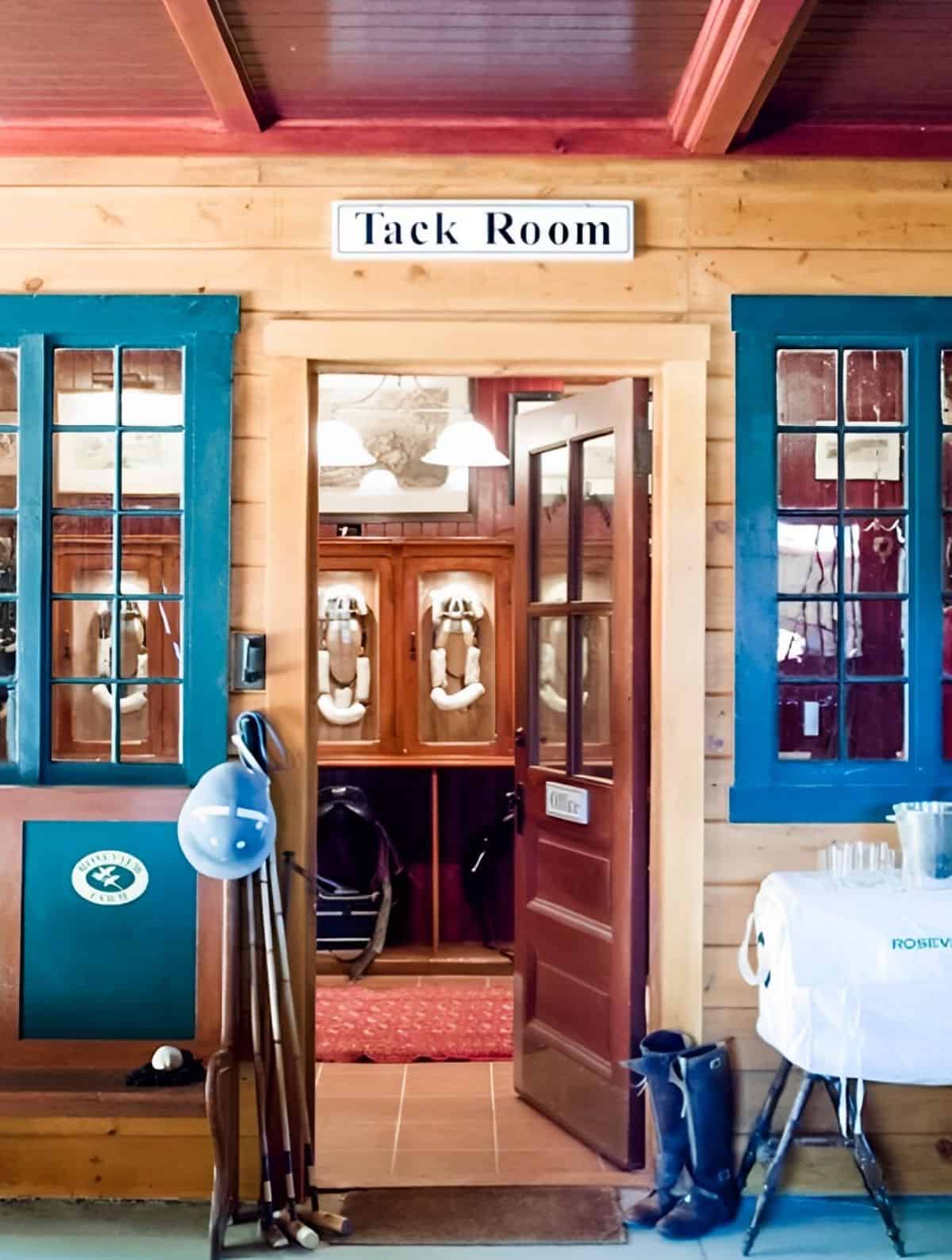 A nicely made tack room filled with horse accessories.