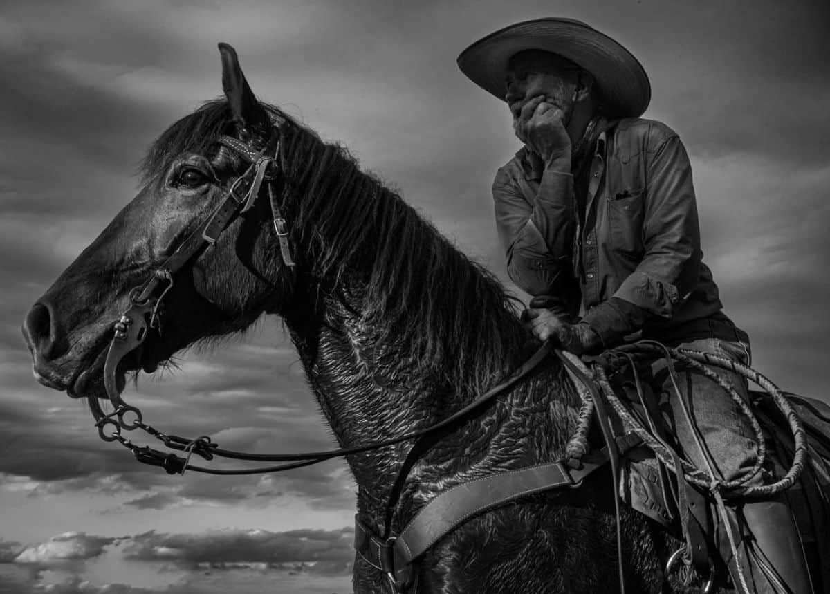 Black and white photo of a man on a ghorse.