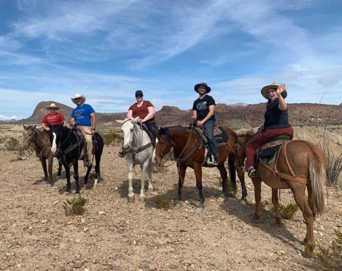 A groupd of people enjoying a horseback ride.