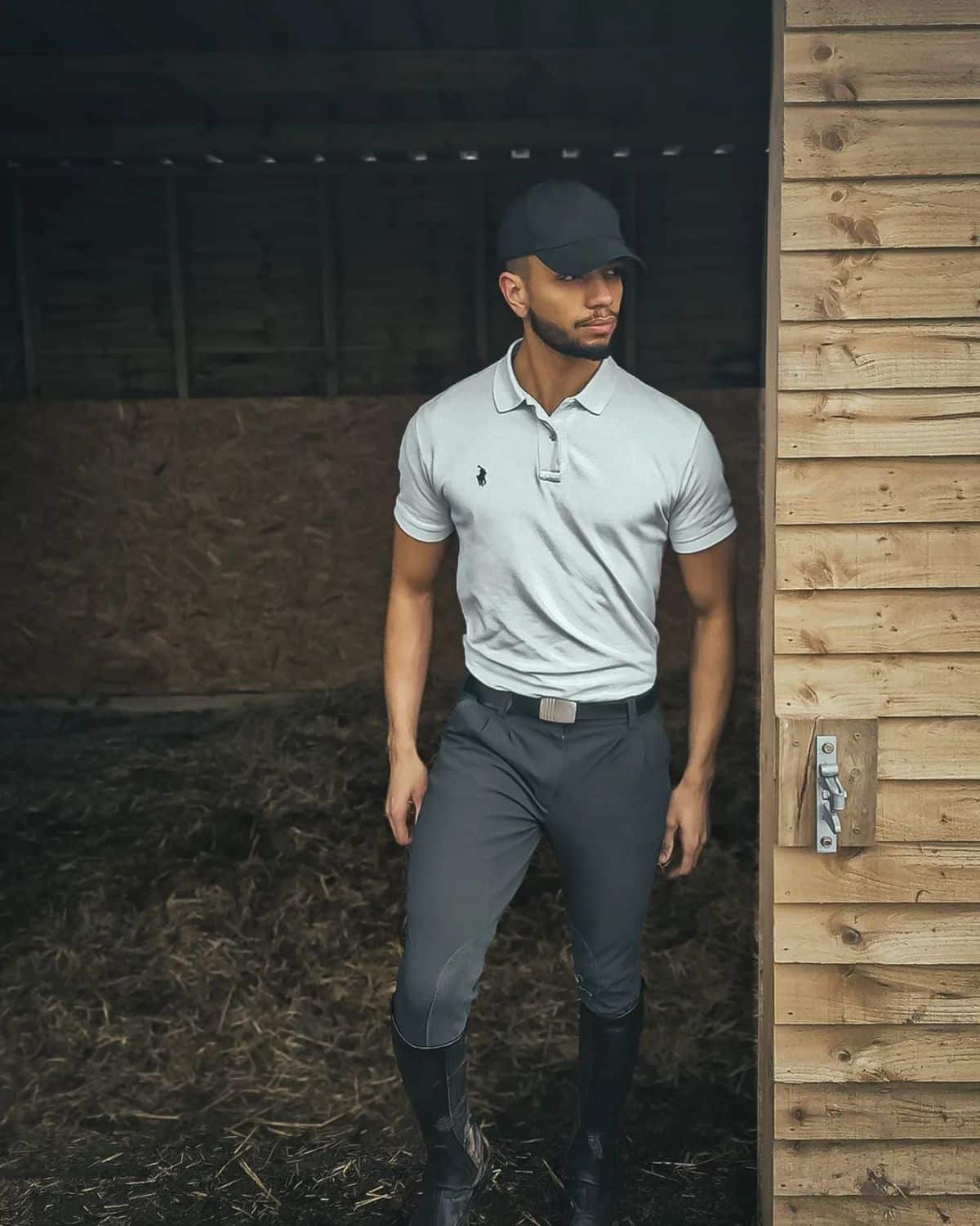 A male Equestrian rider in a stable.