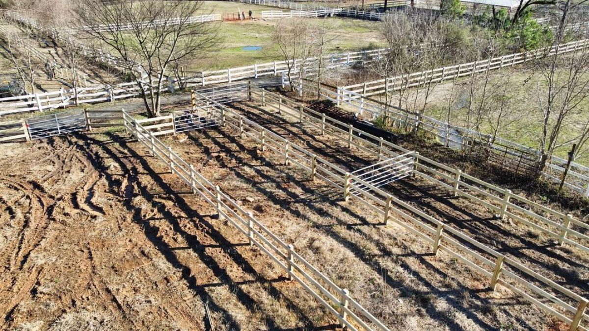 A horse ranch with wooden fences.