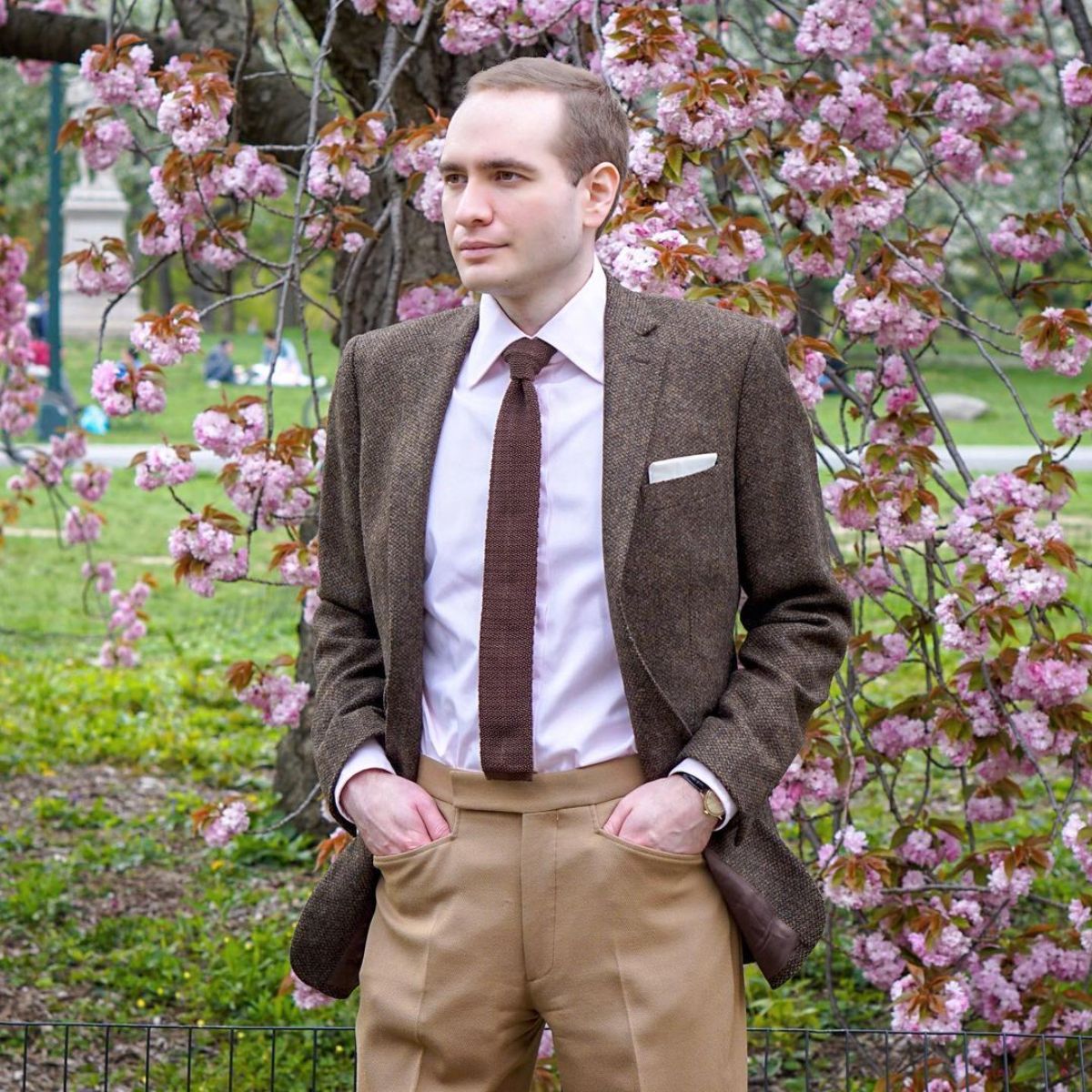 A man wears a classic brown jacket outfit.