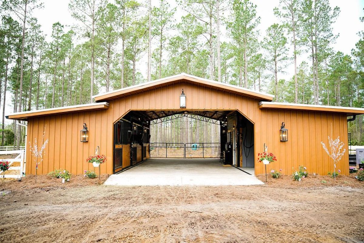 An open wooden horse stall.