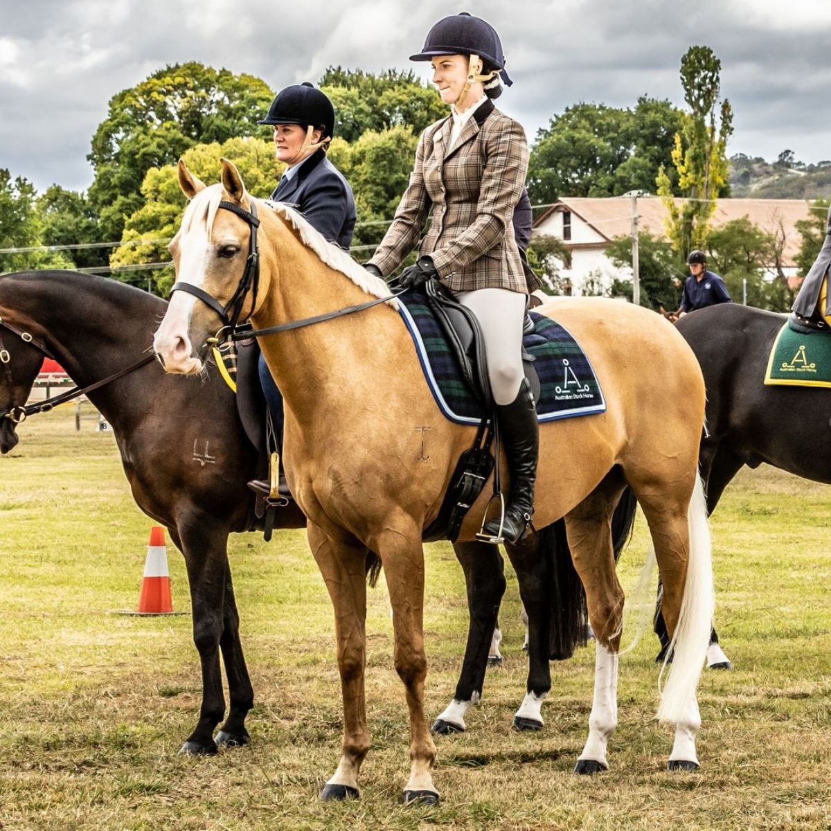 Two women sit on Australian Stock Horses.