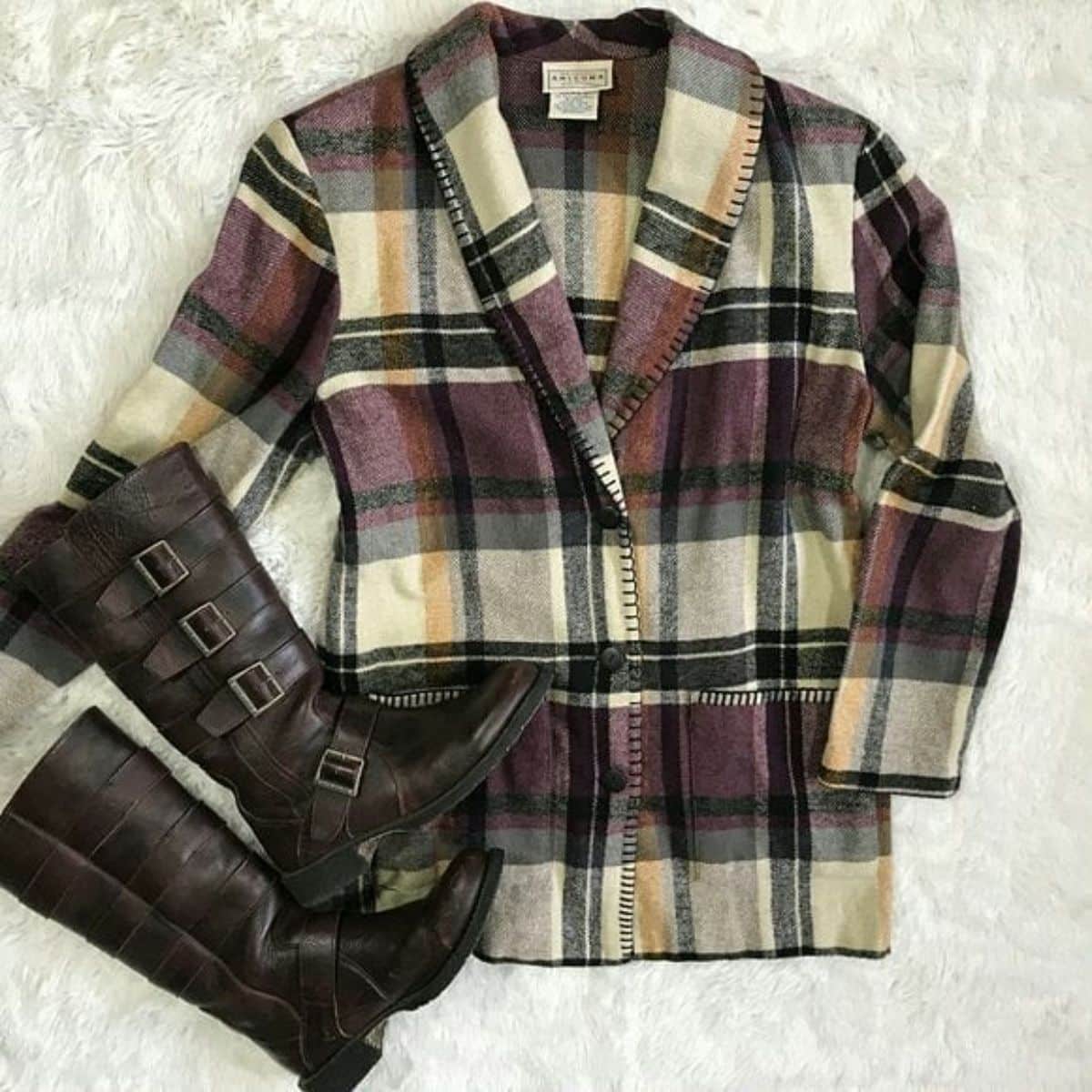 A plaid jacked with leather boots.